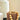 A decor cream pot. This is a beige planter pot with neutral wood chains.