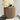 A wood flower pot by Woodland Pulse. This is a cream planter with a white flower.